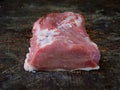 Raw piece of pork loin, breast on a wooden background. Royalty Free Stock Photo