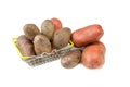 Raw pink potato tubers in a shopping basket on a white isolated background.Potatoes in the skin
