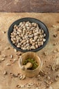 Raw pistachios in a bowl on the background surface, strewn with shells of nuts. Pistachio texture. Nuts. Royalty Free Stock Photo