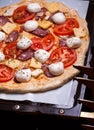 Raw pizza dough with mozzarella and proscuitto on top Royalty Free Stock Photo