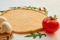 Raw pizza dough on the white background with free copy space. Dough with ingredients for vegetarian pizza: mushrooms, tomato