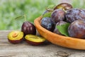 Raw plum on old wooden table Royalty Free Stock Photo