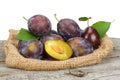 Raw plum on old wooden table Royalty Free Stock Photo