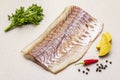 Raw pollock Pollachius virens fillet. Fresh fish for healthy food lifestyle. Lemon, parsley, sea salt, chili, black peppercorn