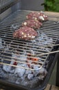 Raw pork and beef meat prepared for hamburgers on barbecue grill treatment on fire Royalty Free Stock Photo