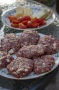 Raw pork and beef meat prepared for hamburgers on white rounded cutting board Royalty Free Stock Photo