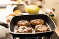 Hamburger cutlet frying on pan in the kitchen