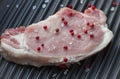 Raw pork chop on the grill pan Royalty Free Stock Photo