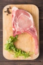 Raw pork chop steak and pepper, vegetable on wooden background Royalty Free Stock Photo