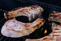 Raw Pork chops cooked on gas barbecue grill Royalty Free Stock Photo