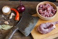 Raw pork chops on cutting board, spices and vegetables Royalty Free Stock Photo