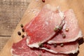 Raw pork chops on cutting board. Uncooked meat steaks for grilling with spices, pepper, salt and greens on wooden background. Top