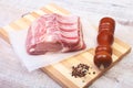 Raw pork chops and spice grinder on cutting board. Ready for cooking.