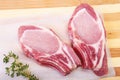 Raw pork chops, spices and rosemary on cutting board. Ready for cooking. Royalty Free Stock Photo