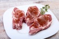 Raw pork chops, spices and rosemary on cutting board. Ready for cooking. Royalty Free Stock Photo