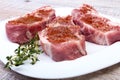 Raw pork chops, spices and rosemary on cutting board. Ready for cooking. Royalty Free Stock Photo