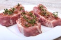 Raw pork chops, spices and rosemary on cutting board. Ready for cooking. Royalty Free Stock Photo