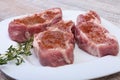 Raw pork chops, spices and rosemary on cutting board. Ready for cooking. Royalty Free Stock Photo