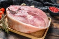 Raw pork ham cut on a wooden board. Leg meat. Dark background. Top view Royalty Free Stock Photo
