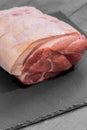 Raw pork joint of meat on slate Royalty Free Stock Photo