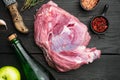 Raw pork meat and ingredients for roast, with apple dry cider, on black wooden table background, top view flat lay Royalty Free Stock Photo