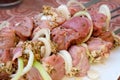 Raw pork meat with onions and spices for cooking kebabs on skewers on the grill. Royalty Free Stock Photo