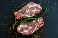 Raw pork meat, rosemary and aromatic herbs