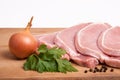 Raw pork meat, vegetables and spices, arranged on kitchen board Royalty Free Stock Photo