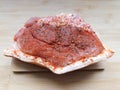 Raw pork meat on wooden cutting board at kitchen table for cooking pork steak roasted or grilled with ingredients herb Royalty Free Stock Photo