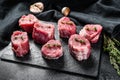 Raw pork medallion steaks with pepper and thyme. black background. Top view Royalty Free Stock Photo