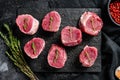 Raw pork medallion steaks with pepper and thyme. black background. Top view Royalty Free Stock Photo