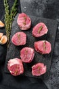 Raw pork medallion steaks with pepper and thyme. black background. Top view Royalty Free Stock Photo