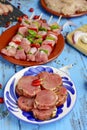 Raw pork medallions and turkey meat skewers