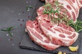 Raw pork neck meat. Chop steak, red peppercorn, garlic cloves, sea salt and fresh rosemary Royalty Free Stock Photo