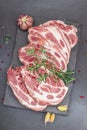 Raw pork neck meat. Chop steak, red peppercorn, garlic cloves, sea salt and fresh rosemary Royalty Free Stock Photo