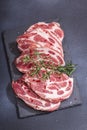 Raw pork neck meat. Chop steak, red peppercorn, garlic cloves, sea salt and fresh rosemary Royalty Free Stock Photo