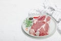 Raw pork neck meat. Chop steak, red peppercorn, garlic cloves, sea salt and fresh rosemary Royalty Free Stock Photo