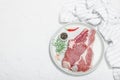 Raw pork neck meat. Chop steak, red peppercorn, garlic cloves, sea salt and fresh rosemary Royalty Free Stock Photo