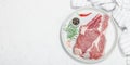 Raw pork neck meat. Chop steak, red peppercorn, garlic cloves, sea salt and fresh rosemary Royalty Free Stock Photo