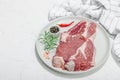 Raw pork neck meat. Chop steak, red peppercorn, garlic cloves, sea salt and fresh rosemary Royalty Free Stock Photo