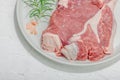 Raw pork neck meat. Chop steak, red peppercorn, garlic cloves, sea salt and fresh rosemary Royalty Free Stock Photo