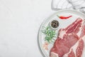 Raw pork neck meat. Chop steak, red peppercorn, garlic cloves, sea salt and fresh rosemary Royalty Free Stock Photo