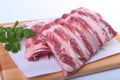 Raw pork ribs with herbs and spices on wooden board. Ready for cooking. Royalty Free Stock Photo