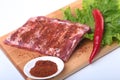 Raw pork ribs with herbs and spices on wooden board. Ready for cooking. Royalty Free Stock Photo