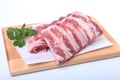 Raw pork ribs with herbs and spices on wooden board. Ready for cooking. Royalty Free Stock Photo