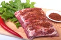 Raw pork ribs with herbs and spices on wooden board. Ready for cooking. Royalty Free Stock Photo