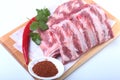 Raw pork ribs with herbs and spices on wooden board. Ready for cooking. Royalty Free Stock Photo