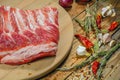 Raw pork ribs laid out on a round cutting board.Spices for cooking meat dishes, close-up.Selective Focus. Royalty Free Stock Photo