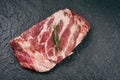 Raw pork ribs meat on black plate background - Fresh pork spare ribs for cooking roasted or grilled , Pork bone with rosemary