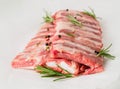 Raw pork ribs with seasoning rosemary, pepper on white parchmen Royalty Free Stock Photo